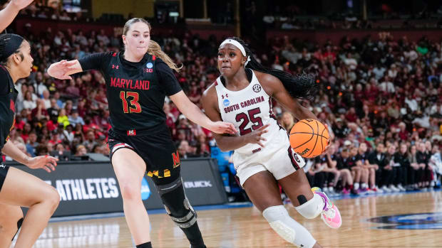 South Carolina Gamecocks guard Raven Johnson dribbles past Maryland Terrapins guard Faith Masonius.